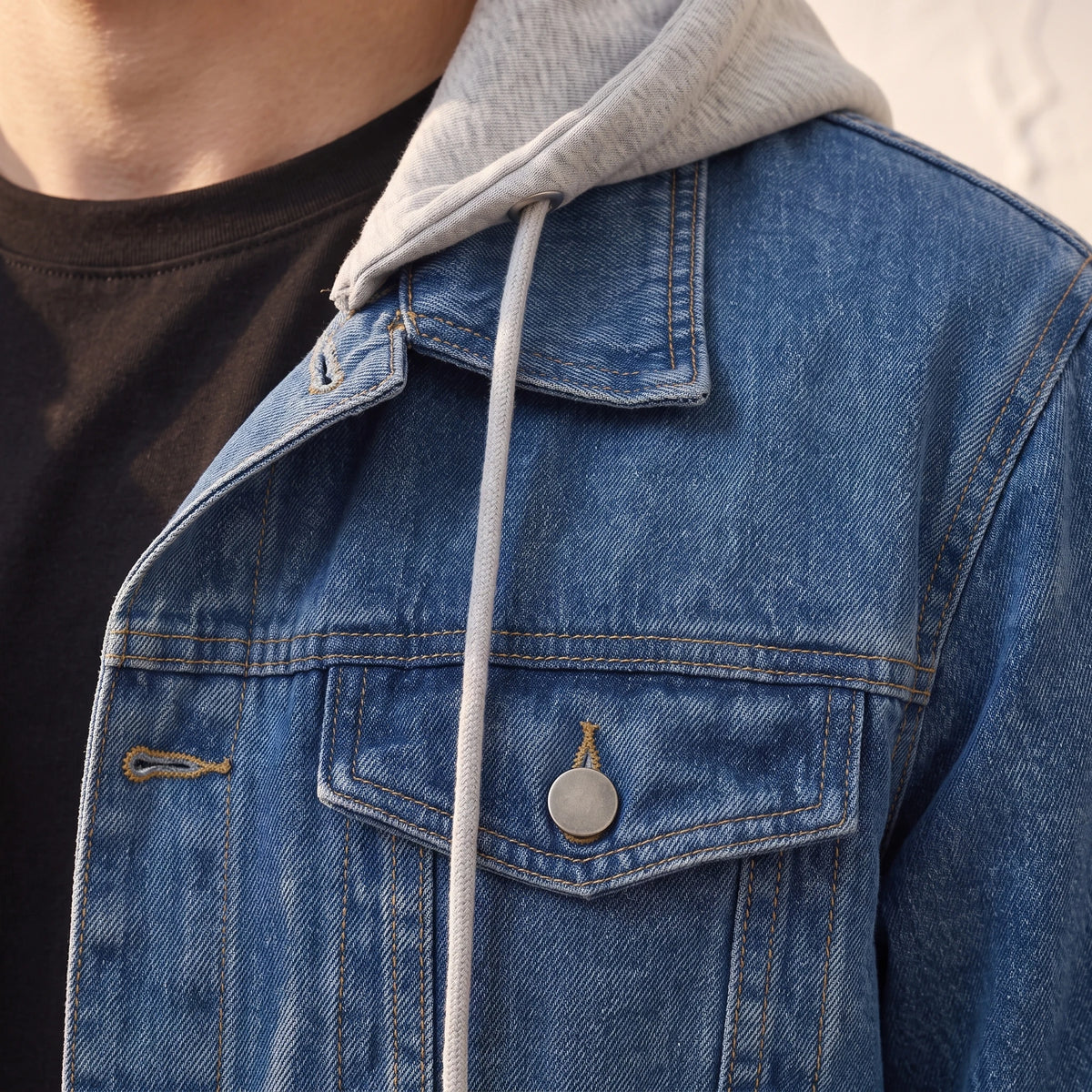 Renvo Trucker Jacket close-up detail of the chest flap pocket, antique silver shank button and grey marl hood