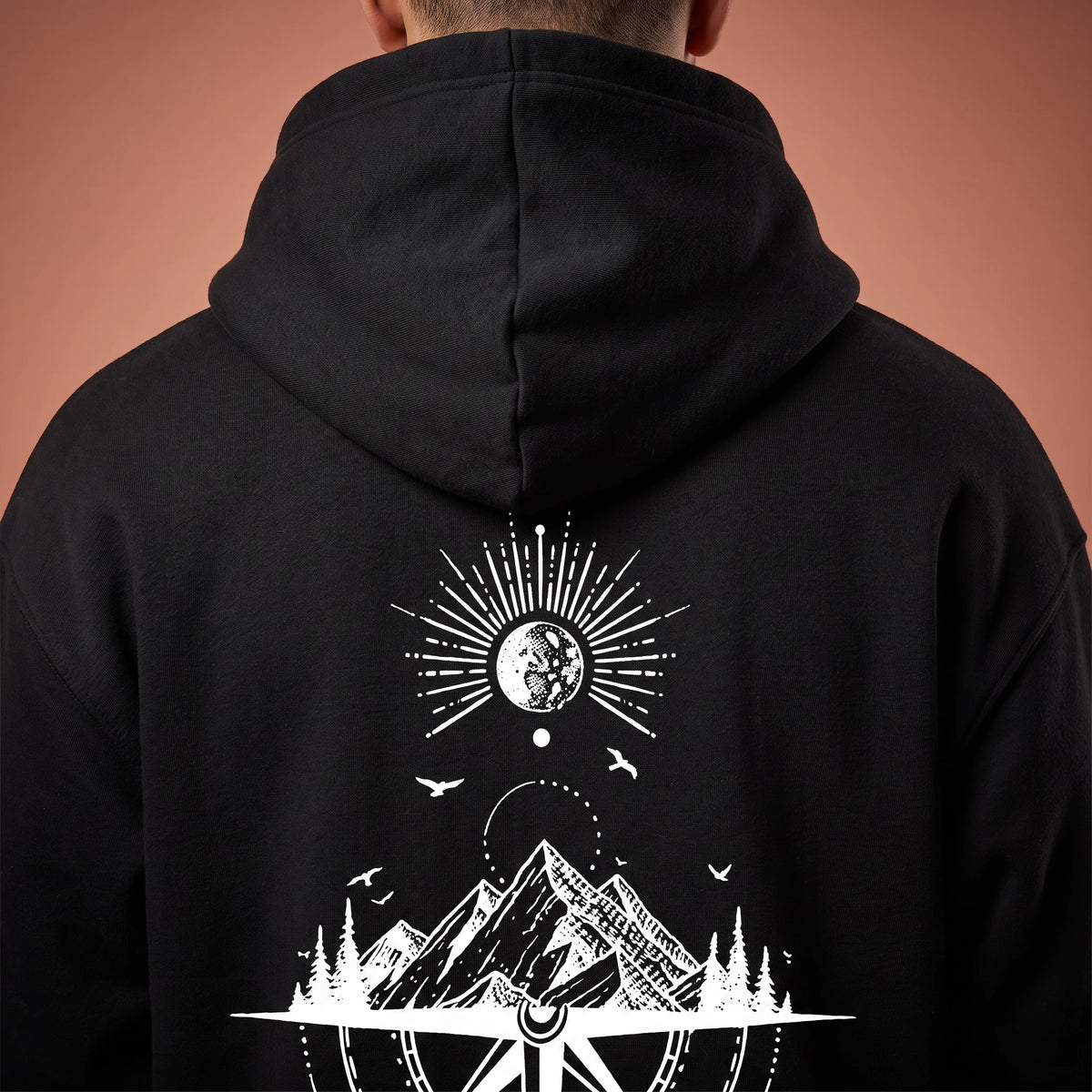 Solane Compass Hoodie in black, close-up detail of the moon, mountain range and compass line drawing on the back