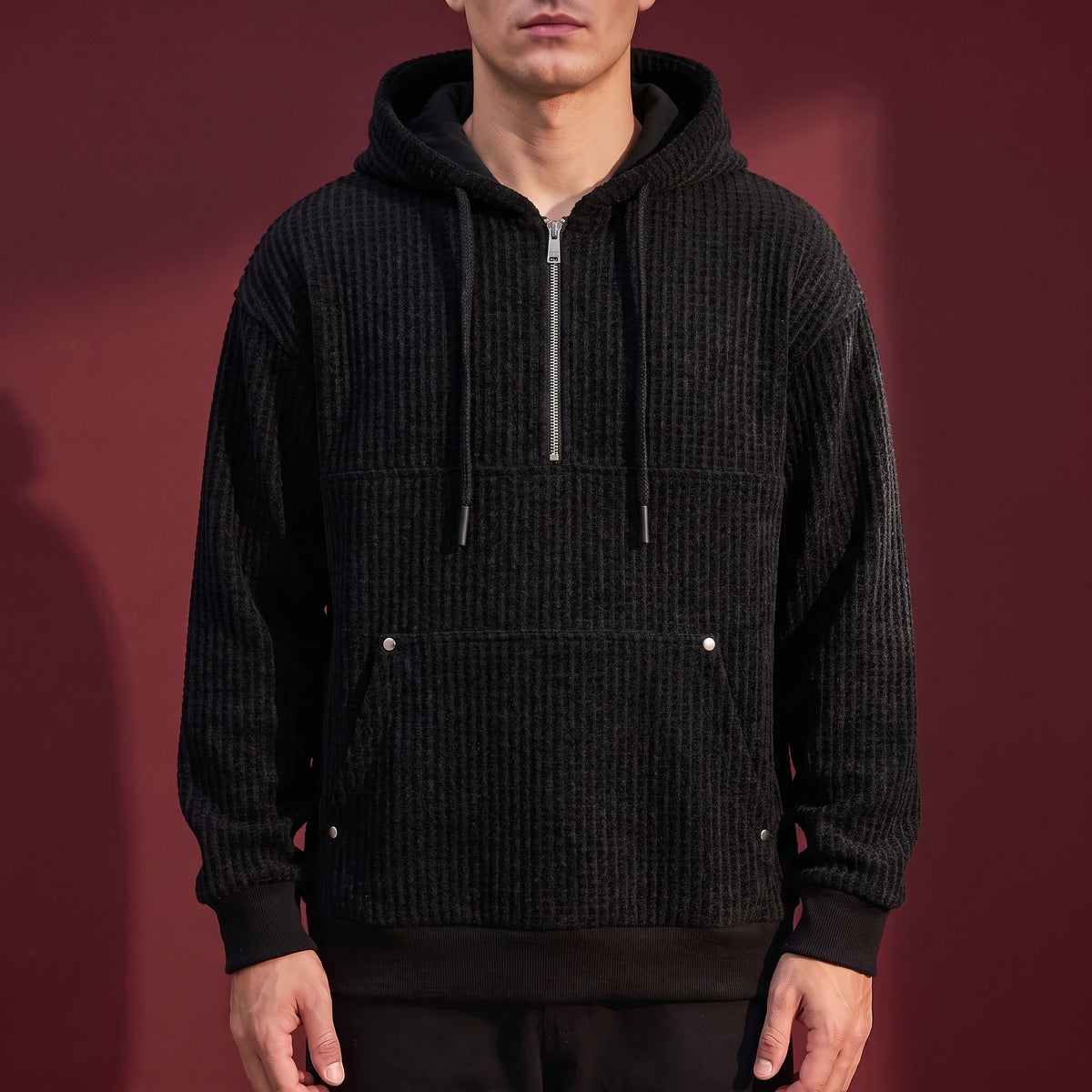 Kaevik Waffle Hoodie in Black - chunky waffle knit quarter-zip hoodie worn by a model