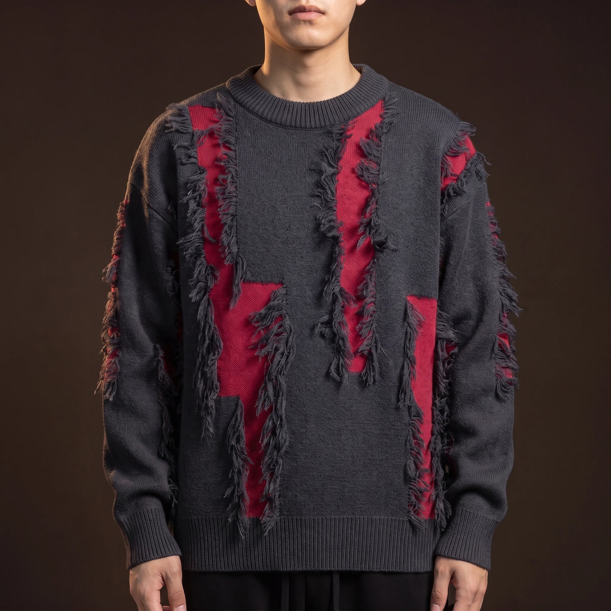 Verrick Distressed Sweater in Red, charcoal crew-neck knit with torn frayed bands opening onto a red under-layer, worn front view