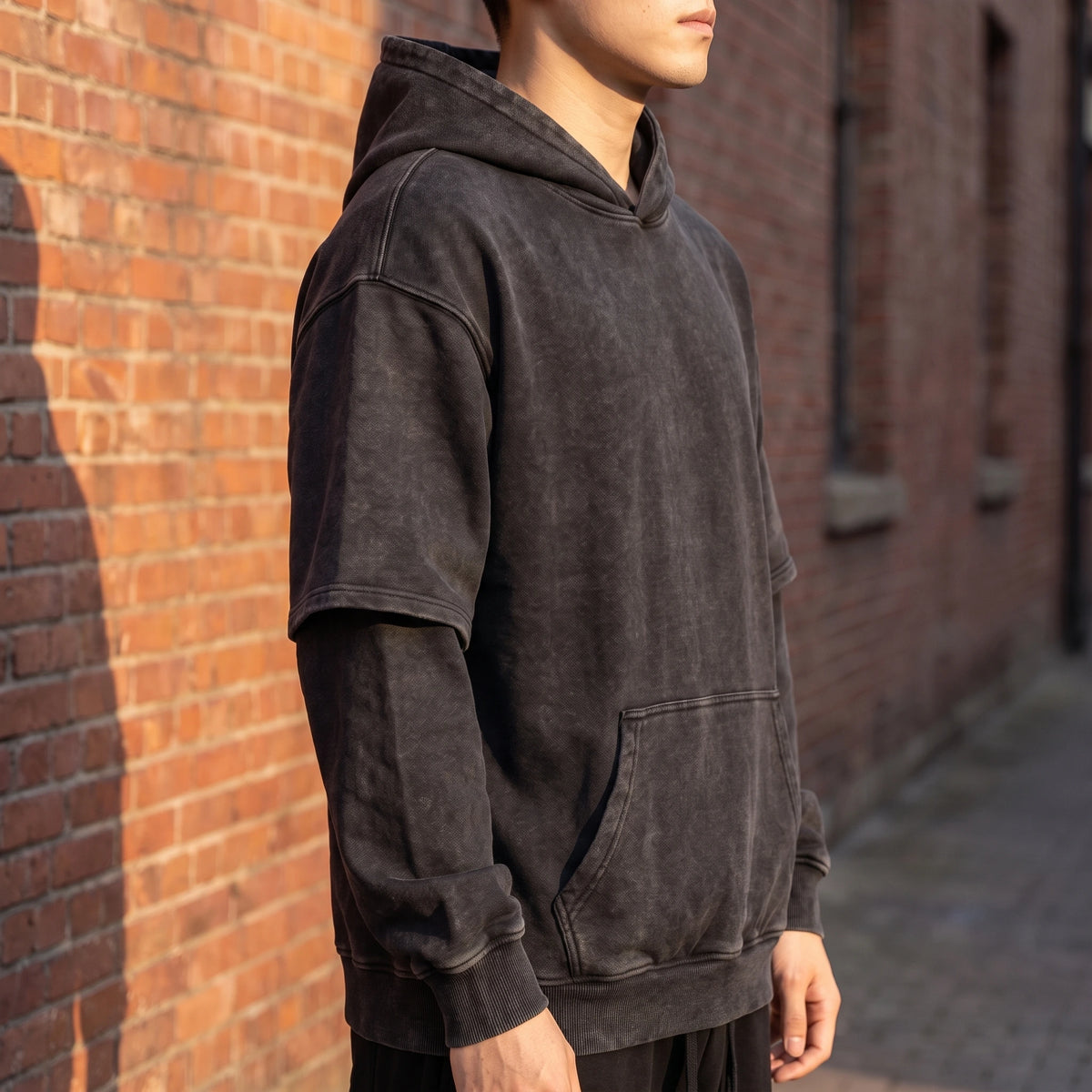Corsten Washed Hoodie side view showing the oversized drop-shoulder fit and layered sleeve seam