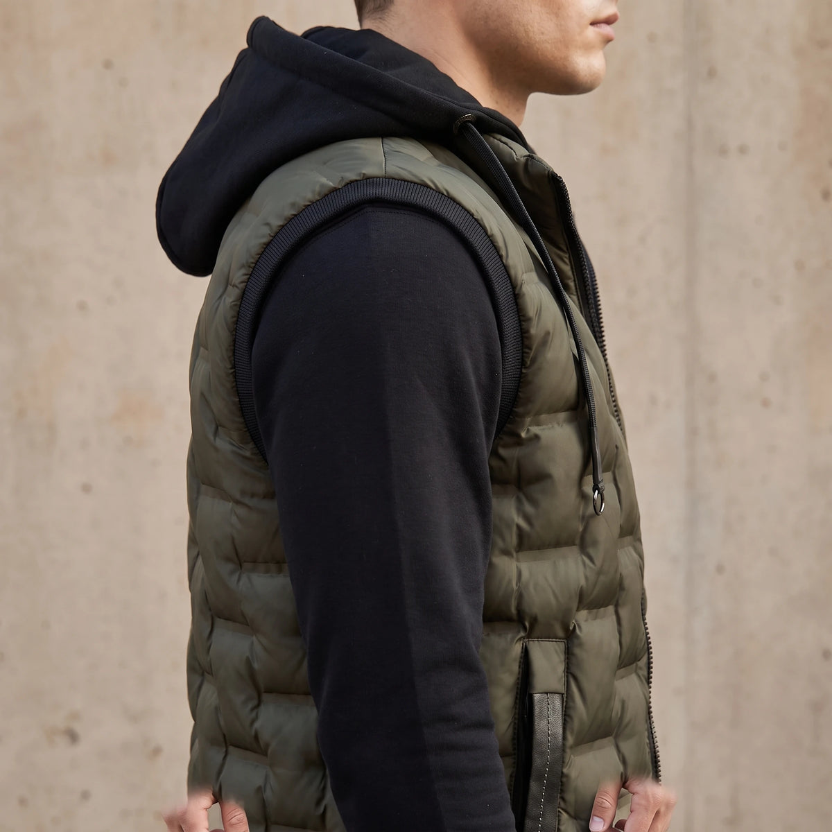 Merrow Padded Vest side view showing the ribbed armhole binding, zip side pocket and quilted panel depth