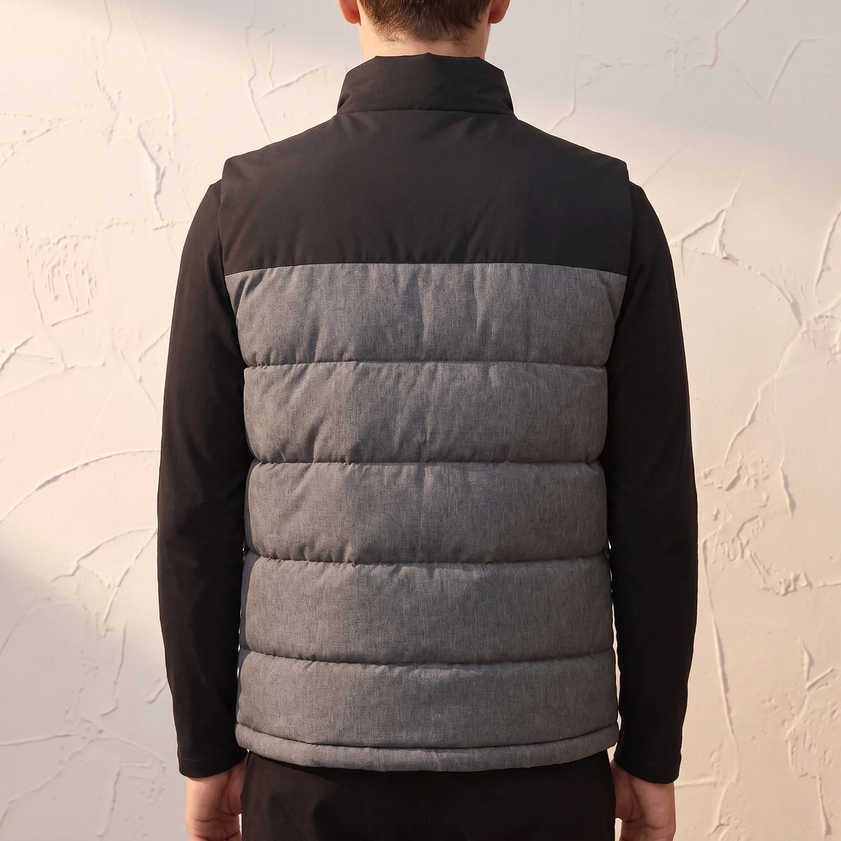 Halvard Padded Vest in Black - back view showing quilted channels and contrast shoulder yoke