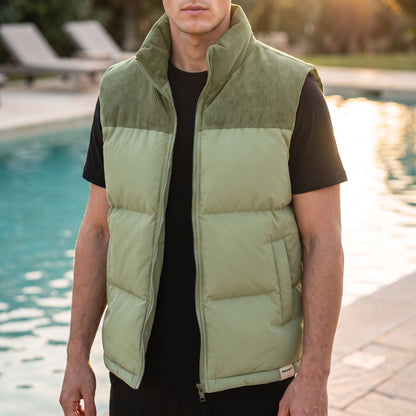 Brancourt Puffer Vest in Green - quilted sleeveless vest with corduroy stand collar worn by a model poolside