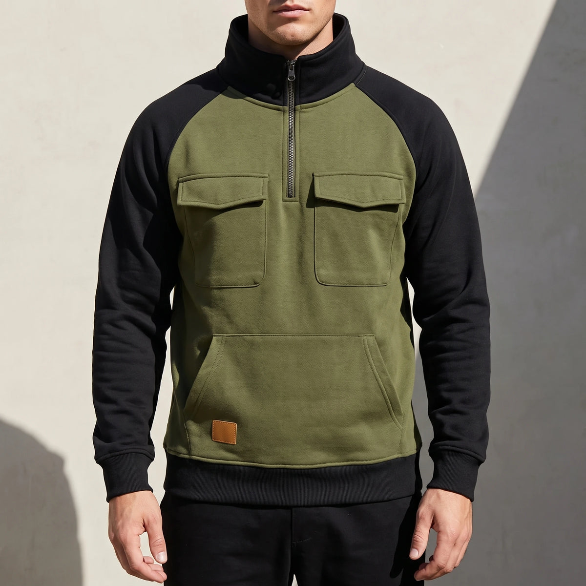 Calvano Half-Zip Sweatshirt in Green - olive funnel-neck pullover with black raglan sleeves worn by a model