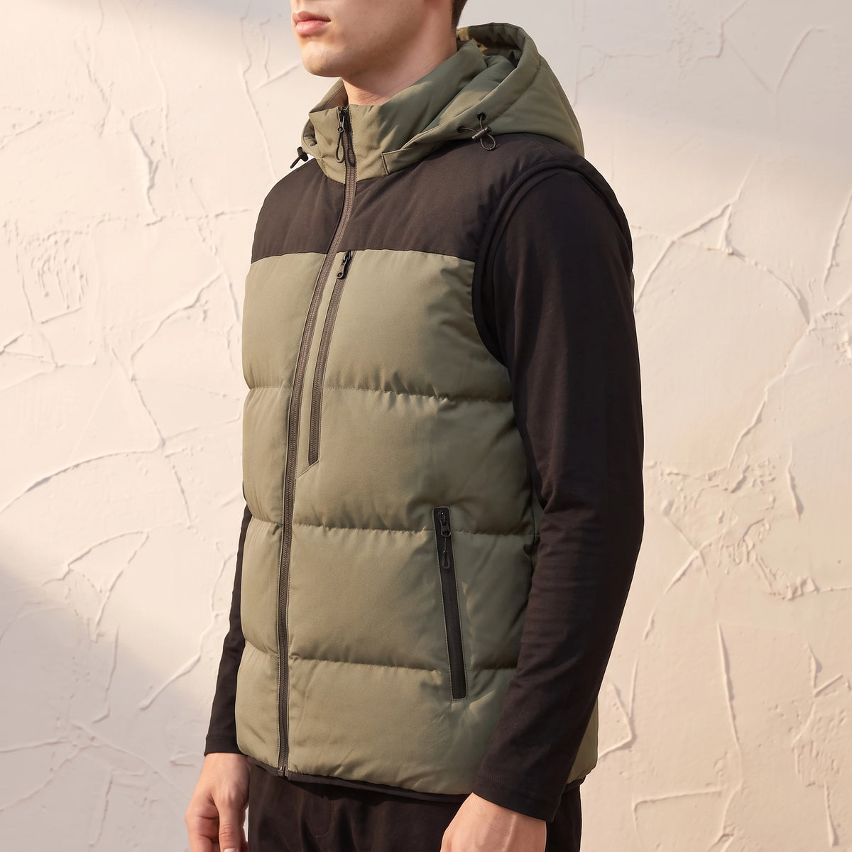 Ashcombe Utility Vest in Green - side view showing zipped hand pocket and bound armhole