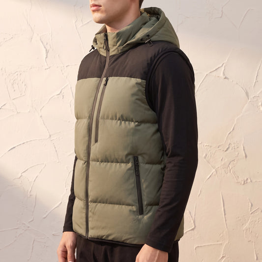 Ashcombe Utility Vest in Green - side view showing zipped hand pocket and bound armhole