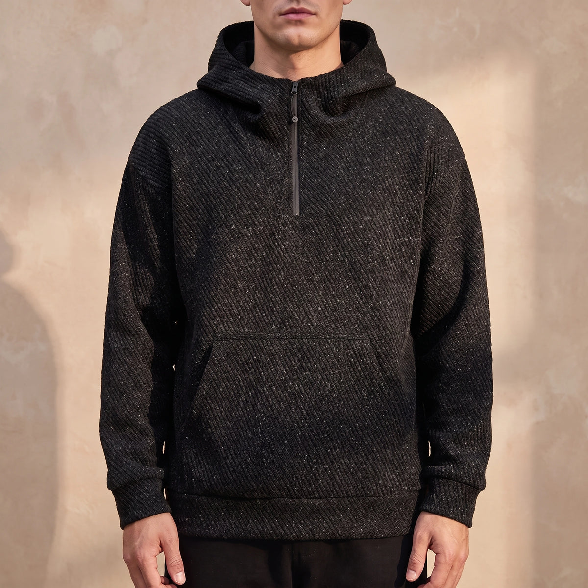 Ostrel Textured Hoodie in Black, oversized diagonal-rib knit hoodie with quarter zip, worn front view