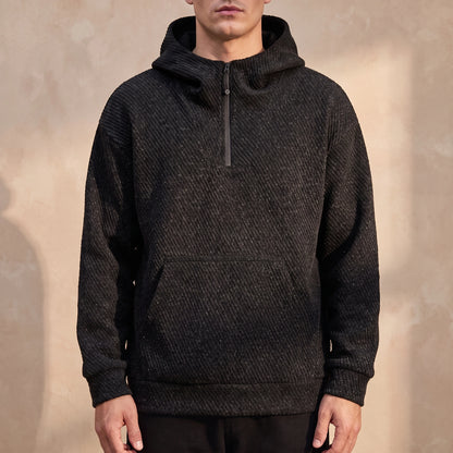 Ostrel Textured Hoodie in Black, oversized diagonal-rib knit hoodie with quarter zip, worn front view