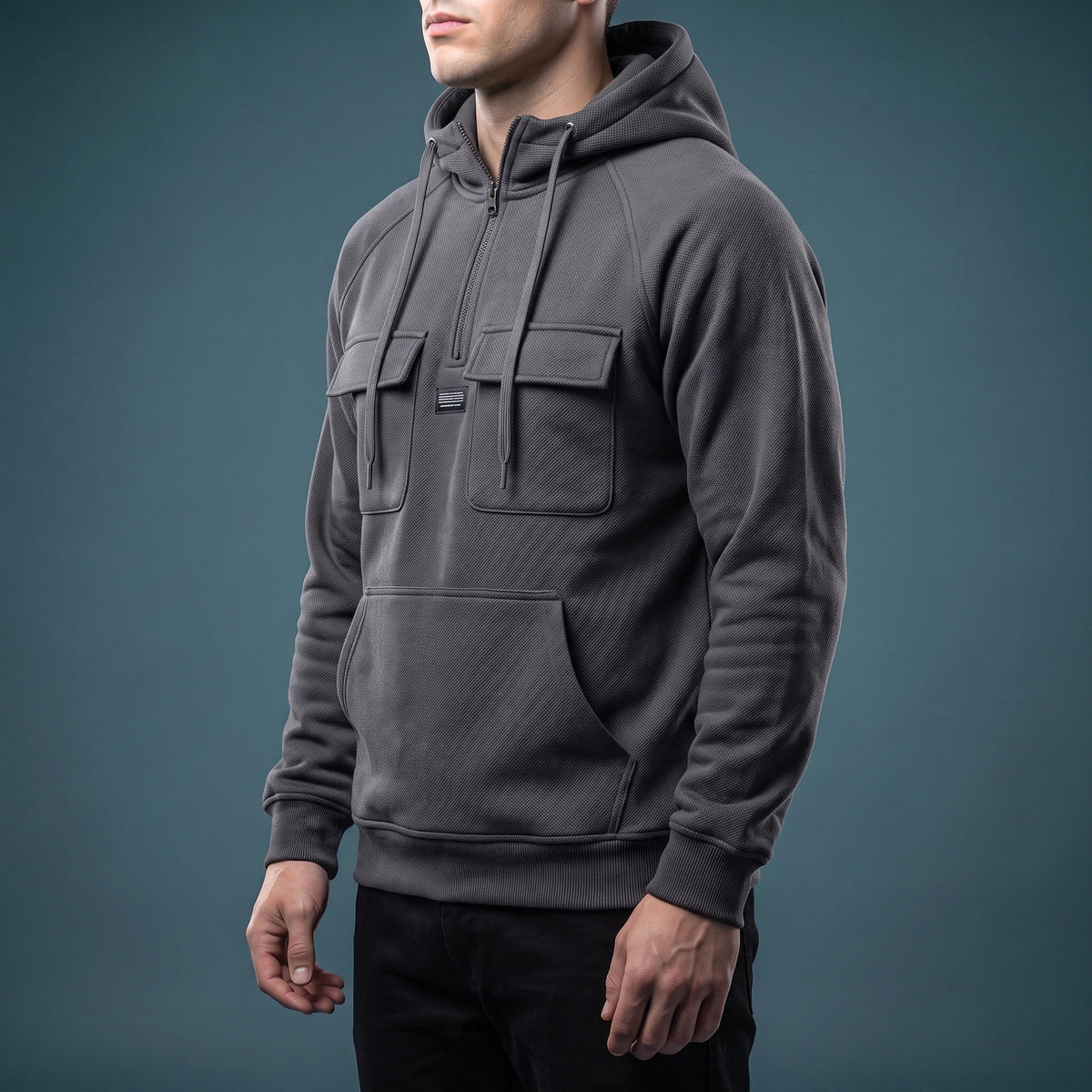 Renholt Utility Hoodie in Charcoal - side view showing flap chest pocket and kangaroo pouch