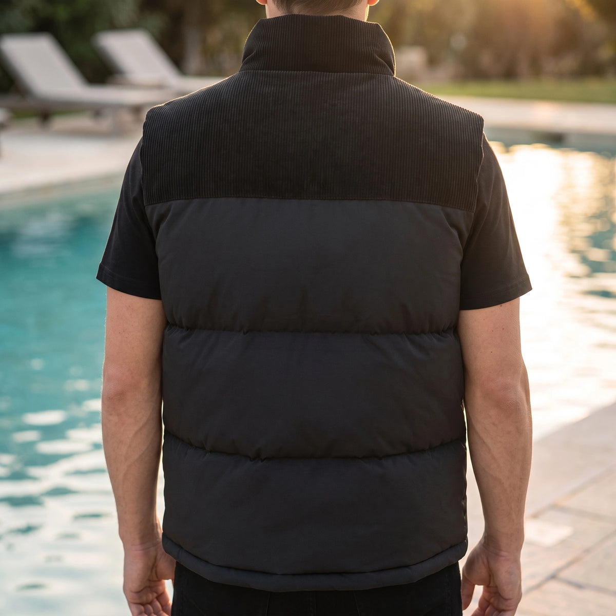 Brancourt Puffer Vest in Black - back view showing corduroy shoulder yoke and quilted channels
