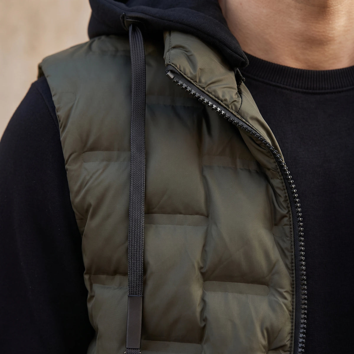 Merrow Padded Vest close-up detail of the front zip teeth, drawcord and quilted panel stitching