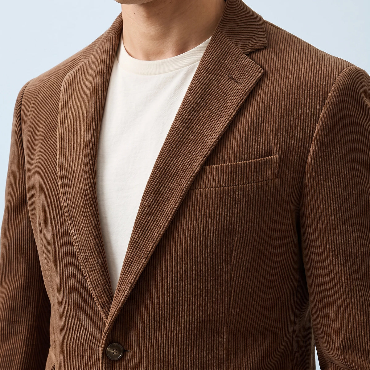 Ashford Corduroy Blazer in brown, men's two-button corduroy blazer with notch lapels, close-up of the lapel, chest pocket and corduroy texture