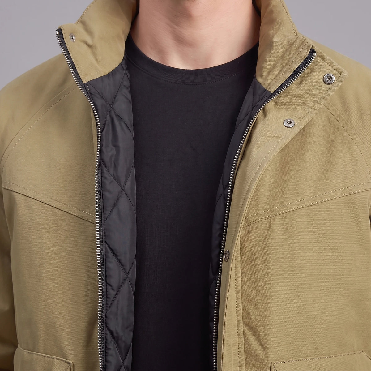 Corvan Stand-Collar Jacket in khaki, men's padded zip jacket with a tall snap collar and patch pockets, close-up of the snap collar, zip and quilted lining