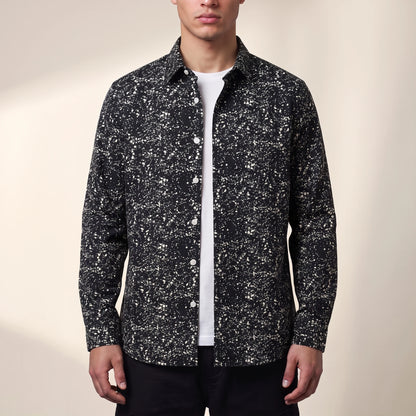 Dorian Layering Shirt in black, men's black shirt with white speckle print, worn open over a white tee