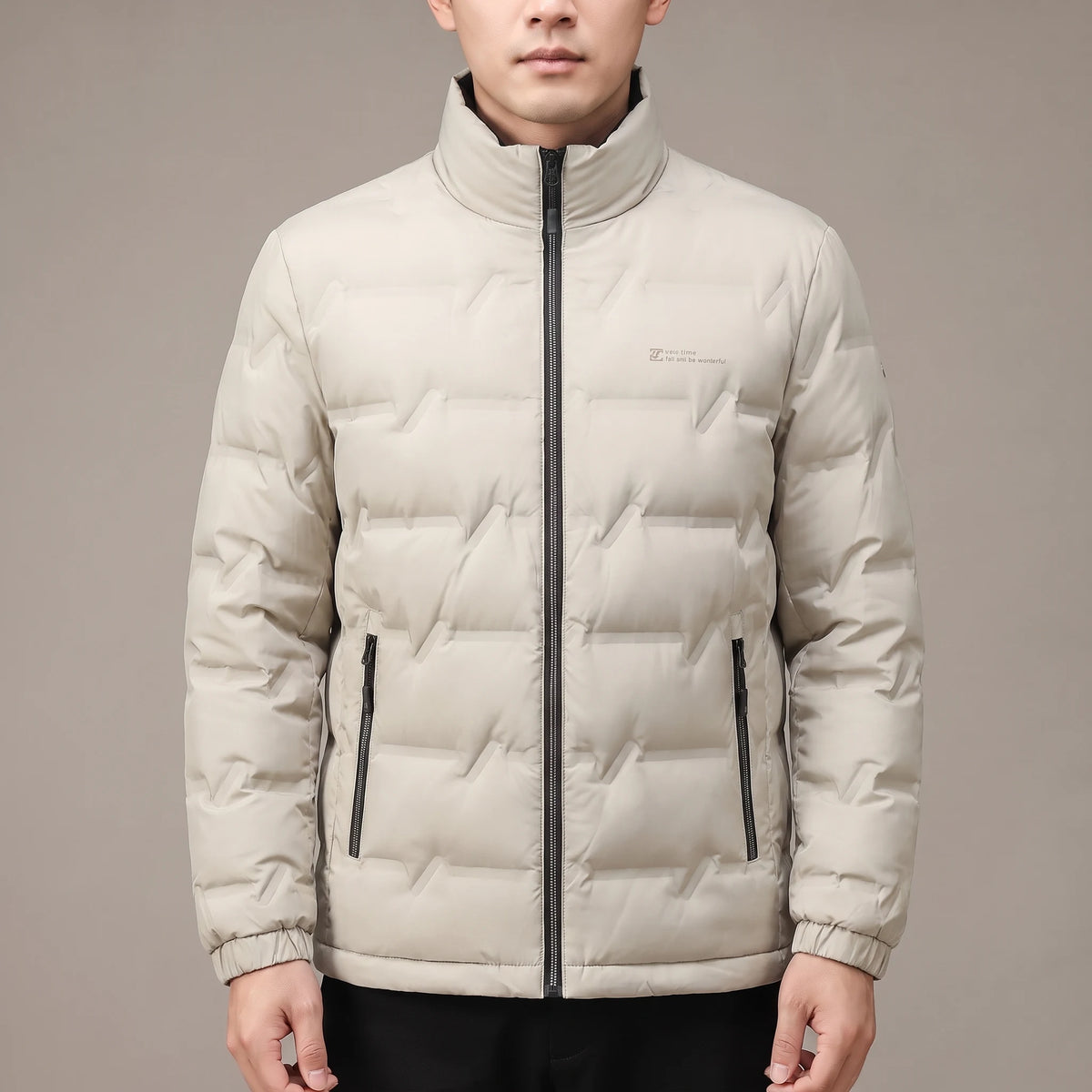 Halden Down Puffer in beige, men's short quilted puffer jacket with dark stand collar, worn in studio