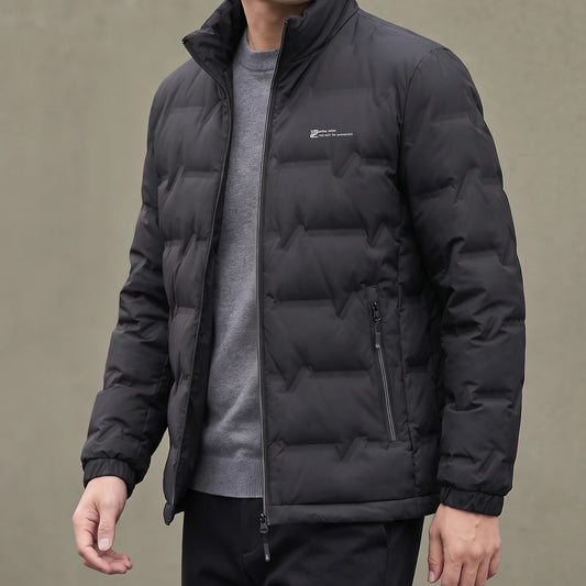 Halden Down Puffer in black, men's short quilted puffer jacket with stand collar, worn open over a grey sweater