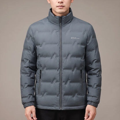 Halden Down Puffer in grey, men's short quilted puffer jacket with zip pockets, worn in studio