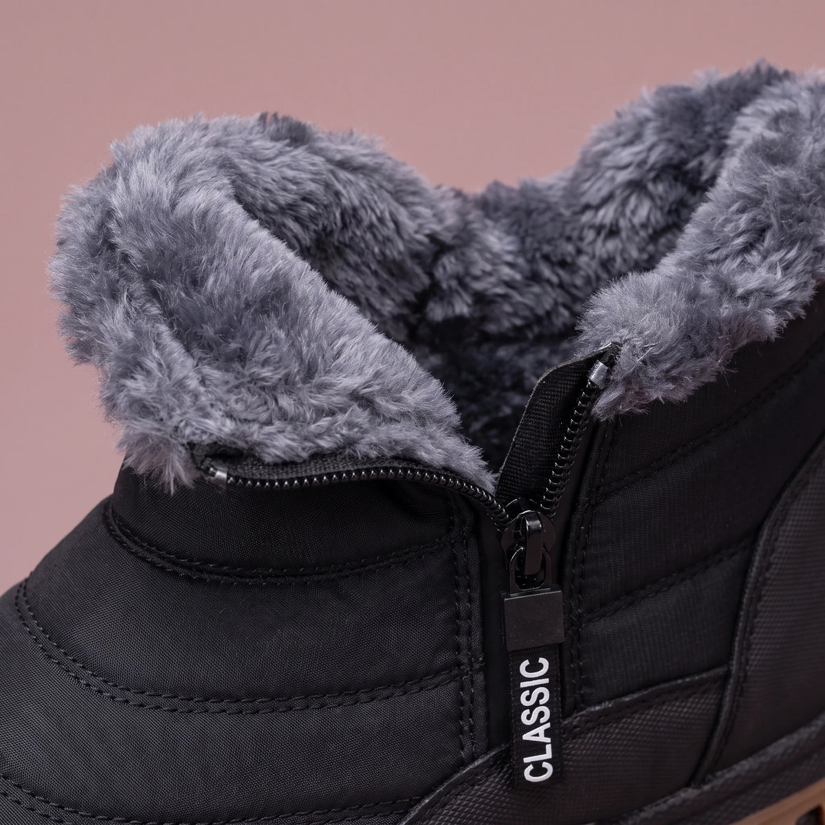 Halvard Fur-Lined Boot in black, men's quilted slip-on ankle boot with plush lining and side zip, close-up of the plush collar and side zip