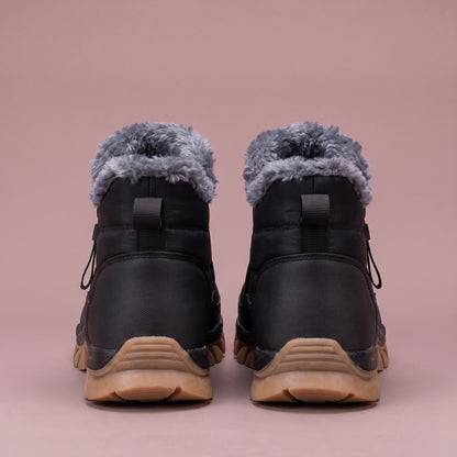 Halvard Fur-Lined Boot in black, men's quilted slip-on ankle boot with plush lining and side zip, pair back view