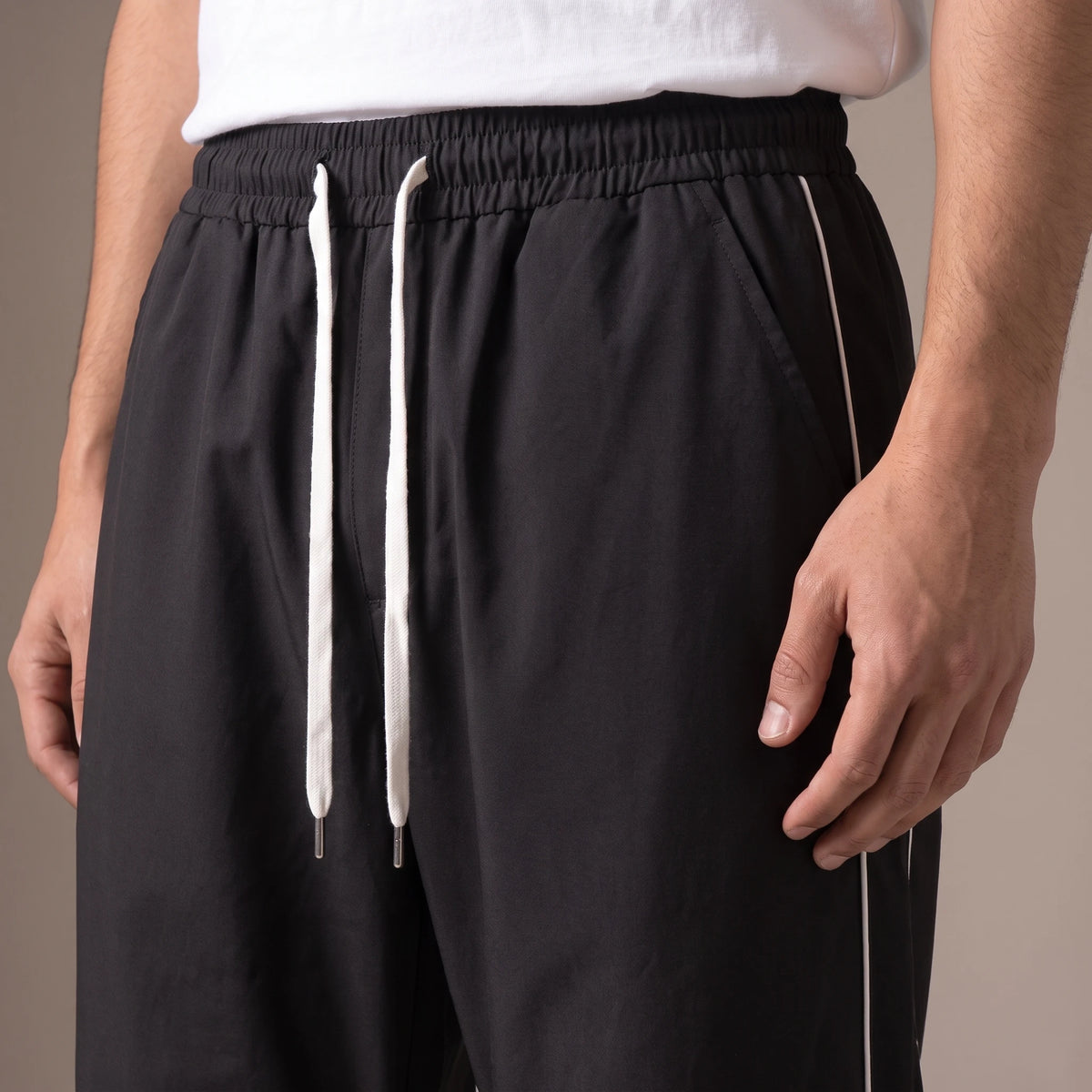 Merrick Piped Track Pant close up of drawcord waistband, slanted pocket and side piping