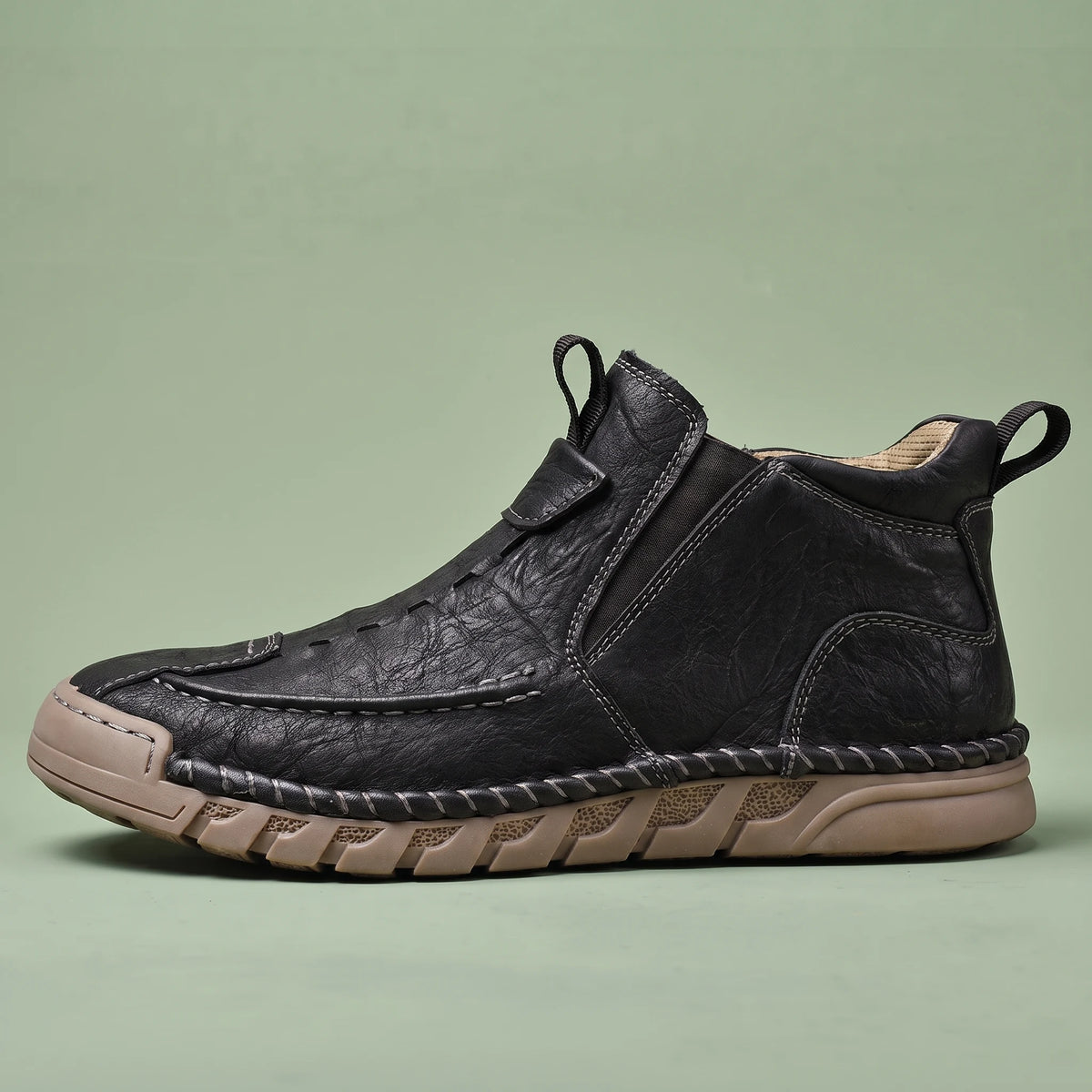 Oswin Leather Chukka in black, men's black slip-on leather chukka ankle boot with tan sole, side view