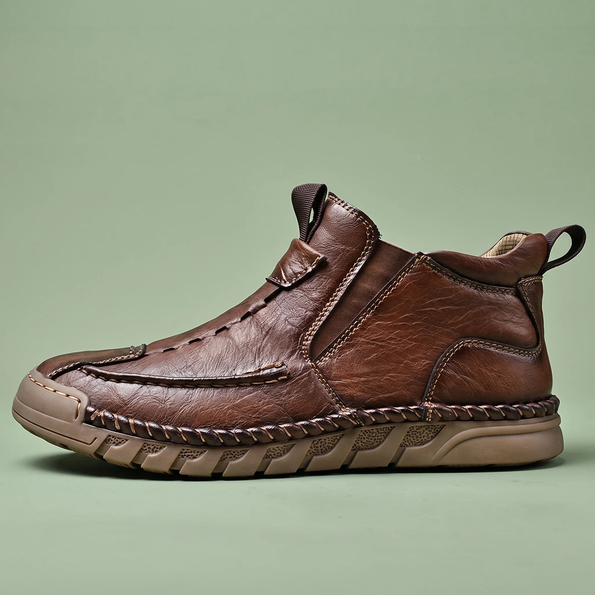 Oswin Leather Chukka in brown, men's slip-on leather chukka ankle boot with hand-stitched moc toe, side view