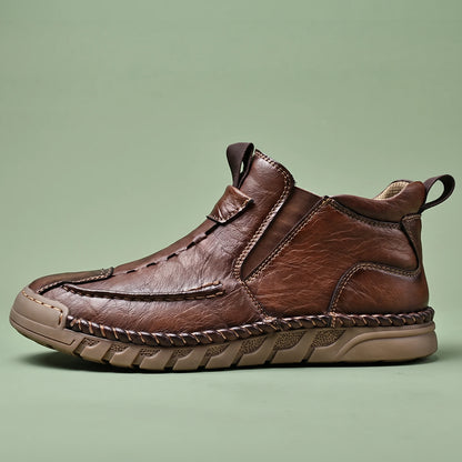 Oswin Leather Chukka in brown, men's slip-on leather chukka ankle boot with hand-stitched moc toe, side view