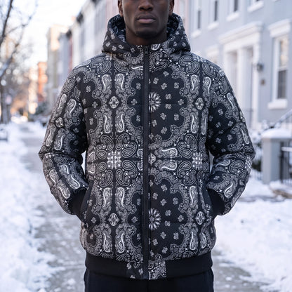 Rennick Paisley Puffer in black, men's black paisley bandana print hooded puffer jacket, worn on snowy street
