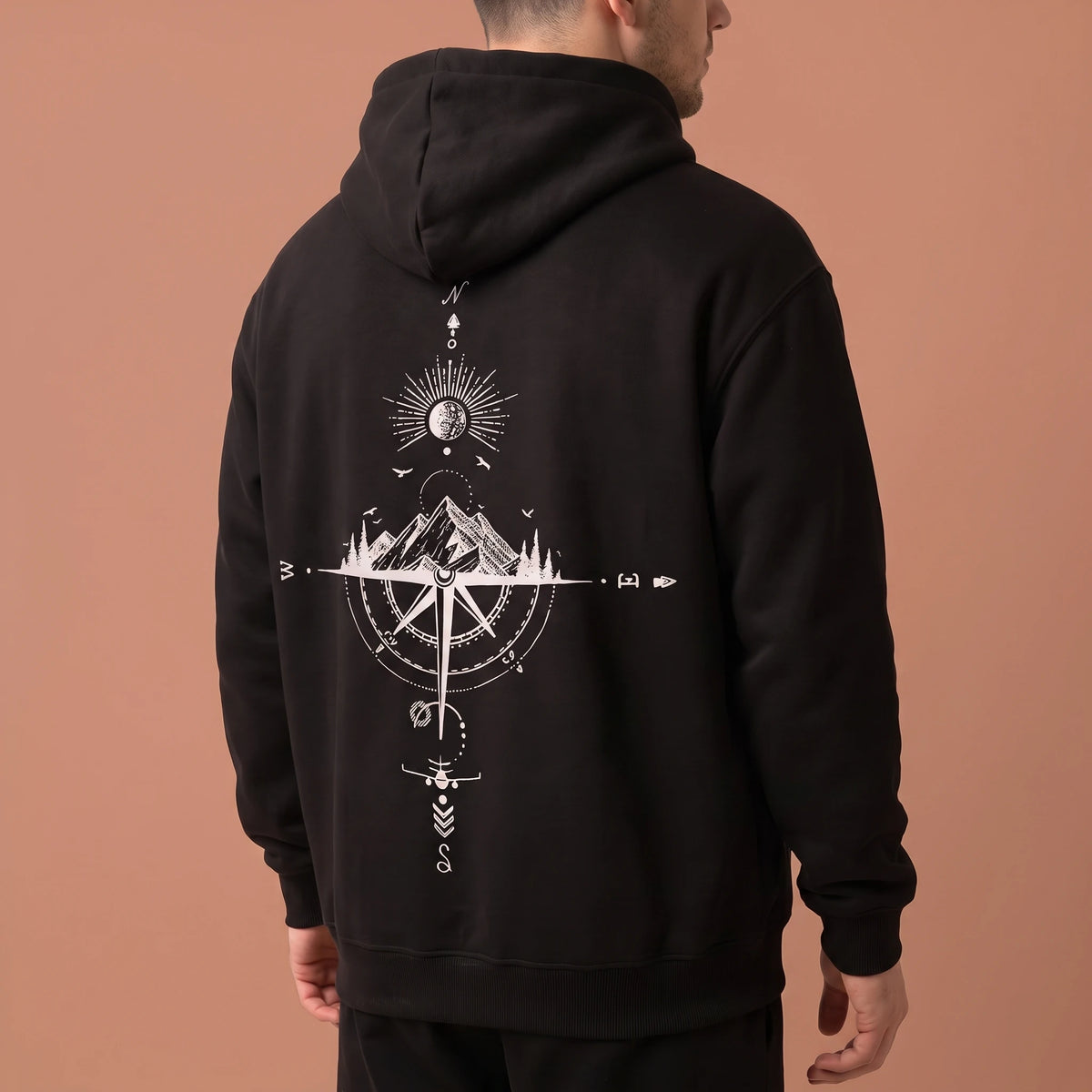 Solane Compass Hoodie in black, three-quarter back angle showing the compass rose artwork and drop shoulder sleeve