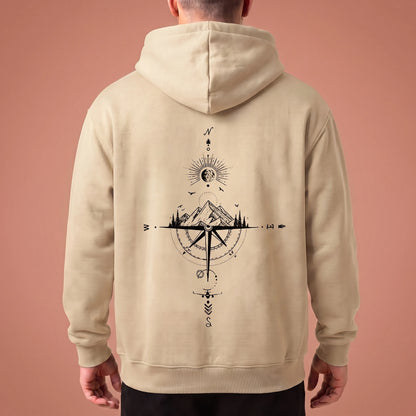 Solane Compass Hoodie in cream, oversized pullover with black compass and mountain line drawing across the back panel, worn by model