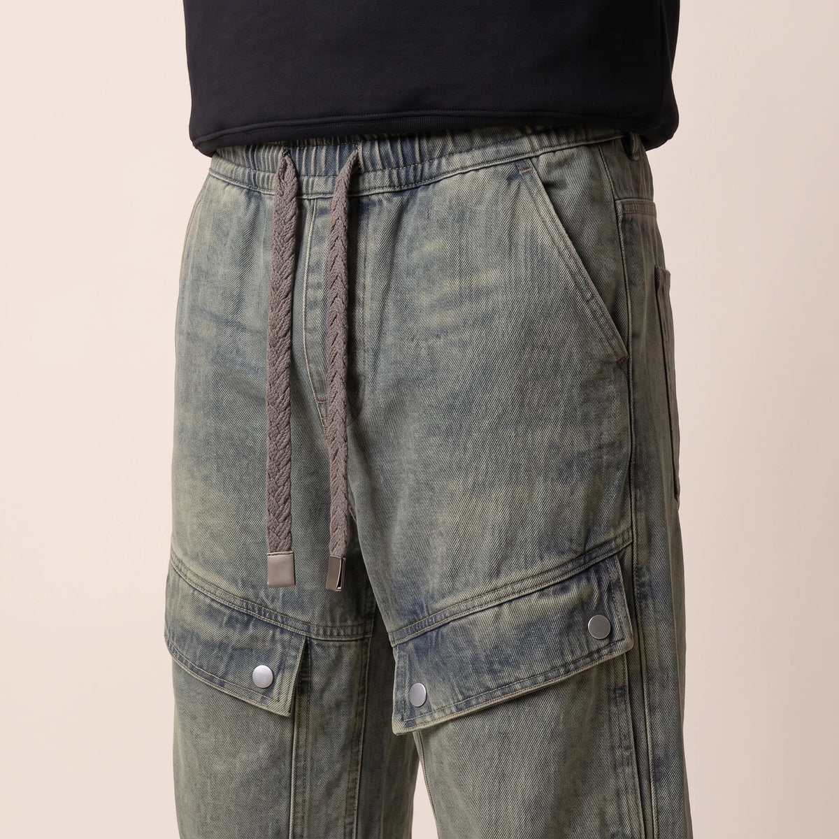 Sorrel Drawcord Jean in vintage wash, men's wide-leg cargo jeans with a drawcord waist and snap-flap thigh pockets, close-up of the braided drawcord and snap-flap pocket