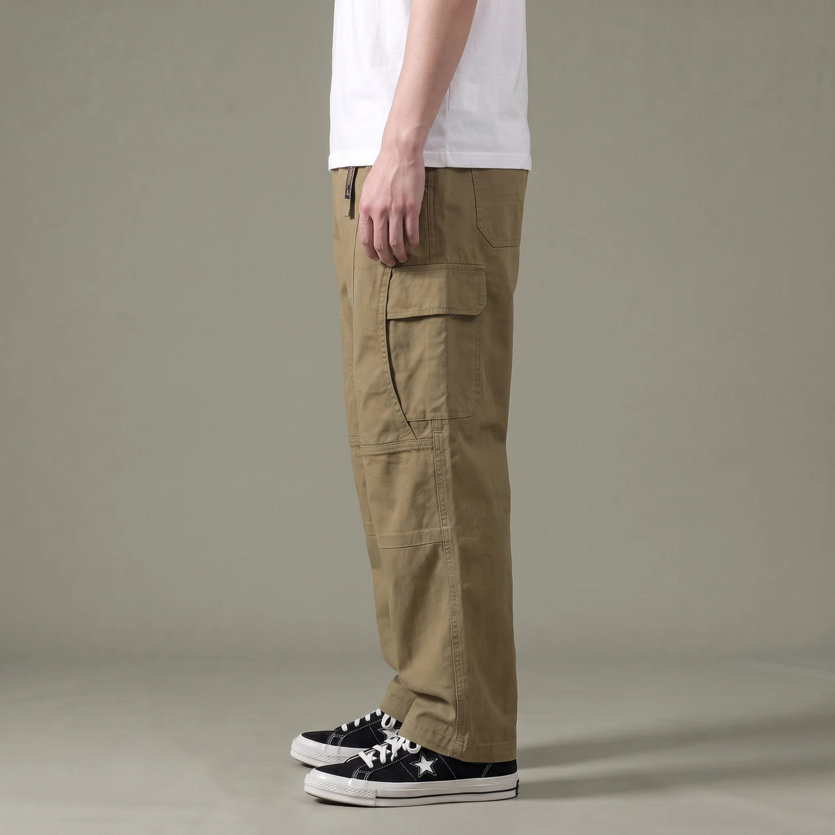 Tate Field Cargo Pant in khaki, men's loose straight-leg cargo pants with flap pockets, side view showing the flap cargo pocket
