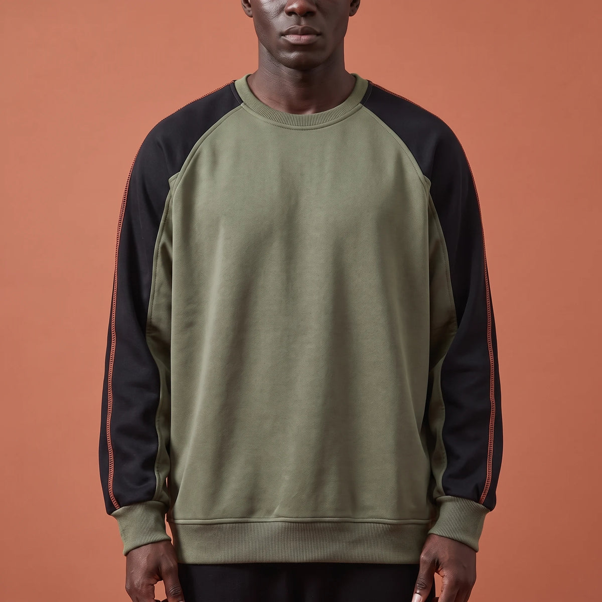 Tavish Stitch Crewneck in green, men's olive raglan crewneck sweatshirt with black contrast sleeves and orange stitch line