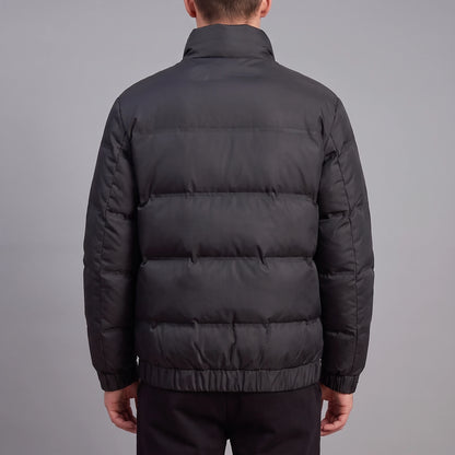 Torvald Down Jacket black down puffer, back view with quilted channels and elastic hem