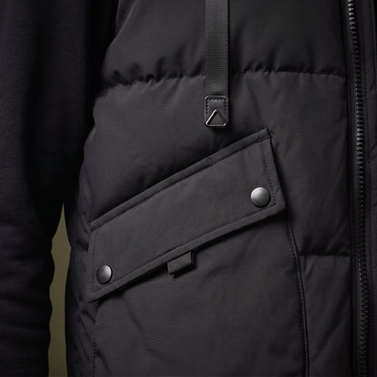 Norvell Hooded Gilet close-up detail of the flap pocket, press stud, welt zip and webbing strap tab