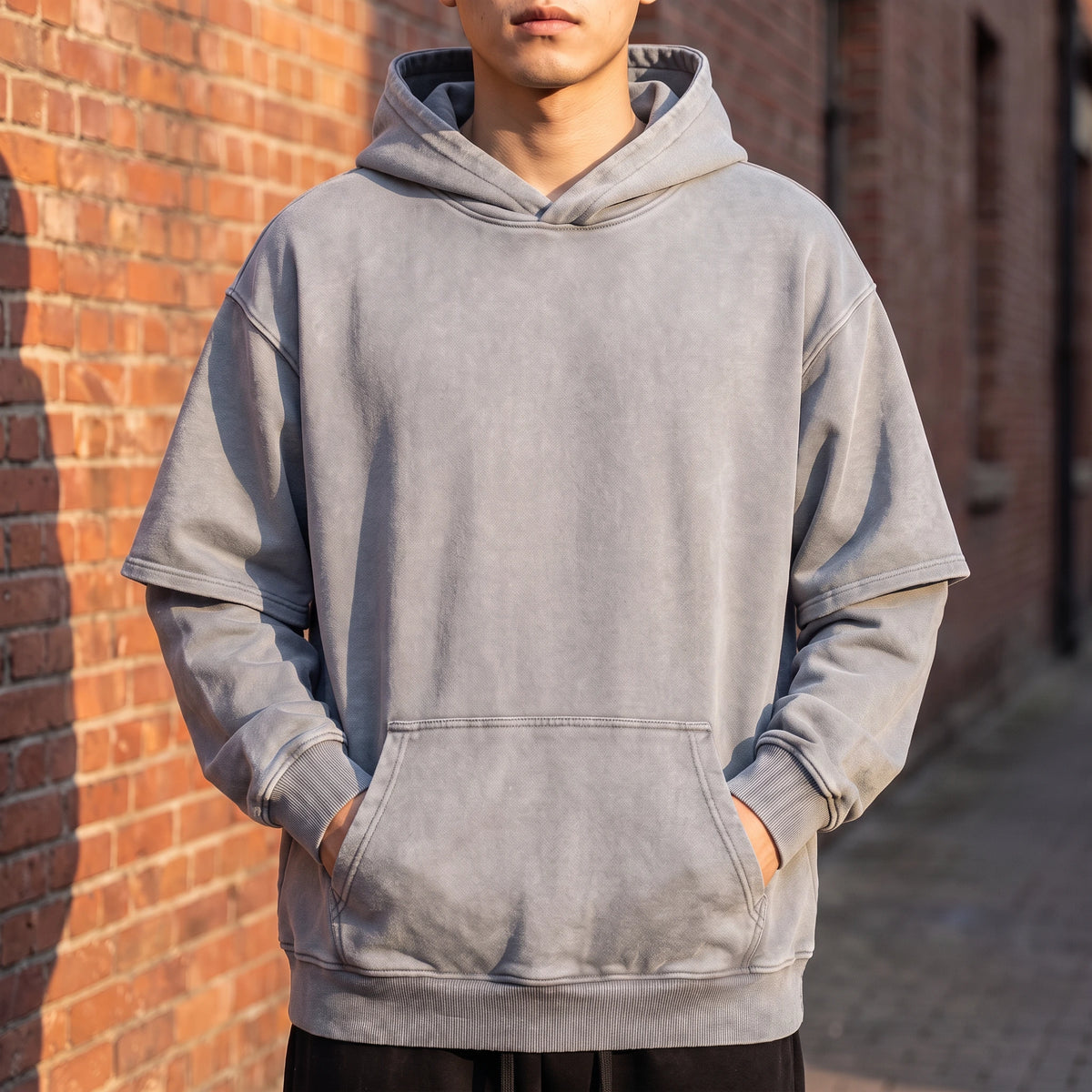 Corsten Washed Hoodie in Grey, washed cotton oversized pullover hoodie with layered fake two-piece sleeves, worn front view
