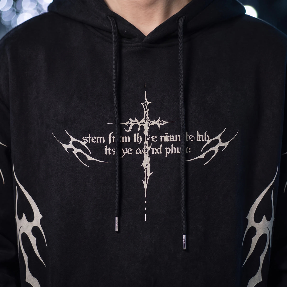 Vaskel Thorn Hoodie close-up detail of the off-white gothic thorn-cross chest print and flat woven drawcords on brushed fleece