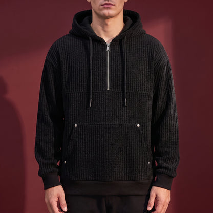Kaevik Waffle Hoodie in Black - chunky waffle knit quarter-zip hoodie worn by a model