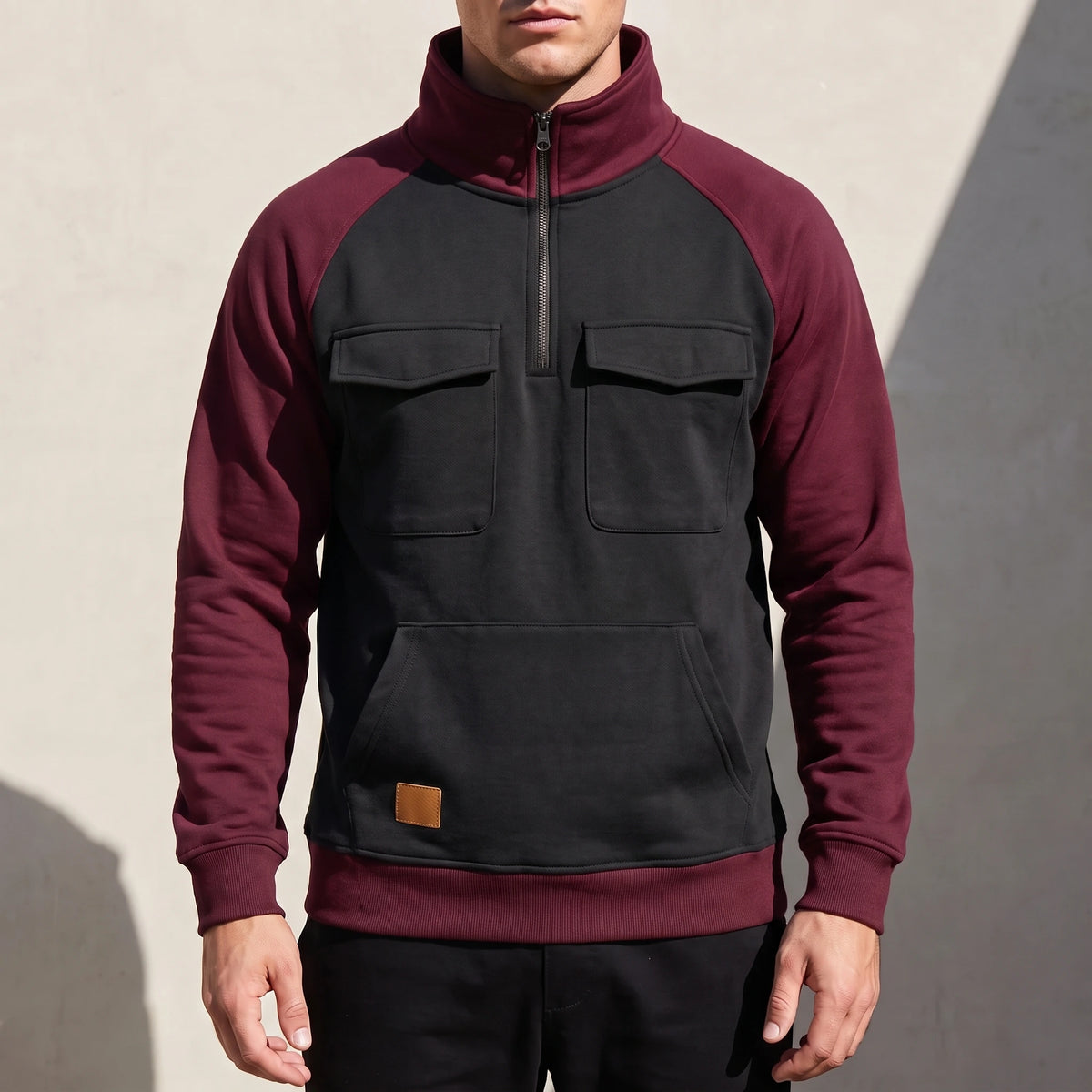 Calvano Half-Zip Sweatshirt in Black - black funnel-neck pullover with burgundy raglan sleeves worn by a model