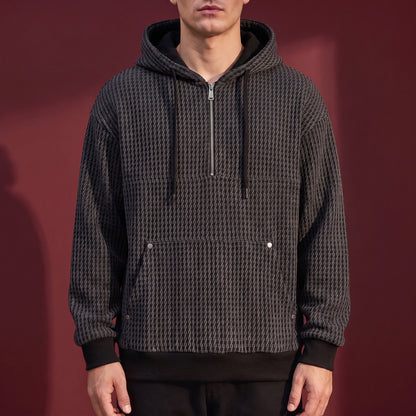 Kaevik Waffle Hoodie in Charcoal - chunky waffle knit quarter-zip hoodie worn by a model