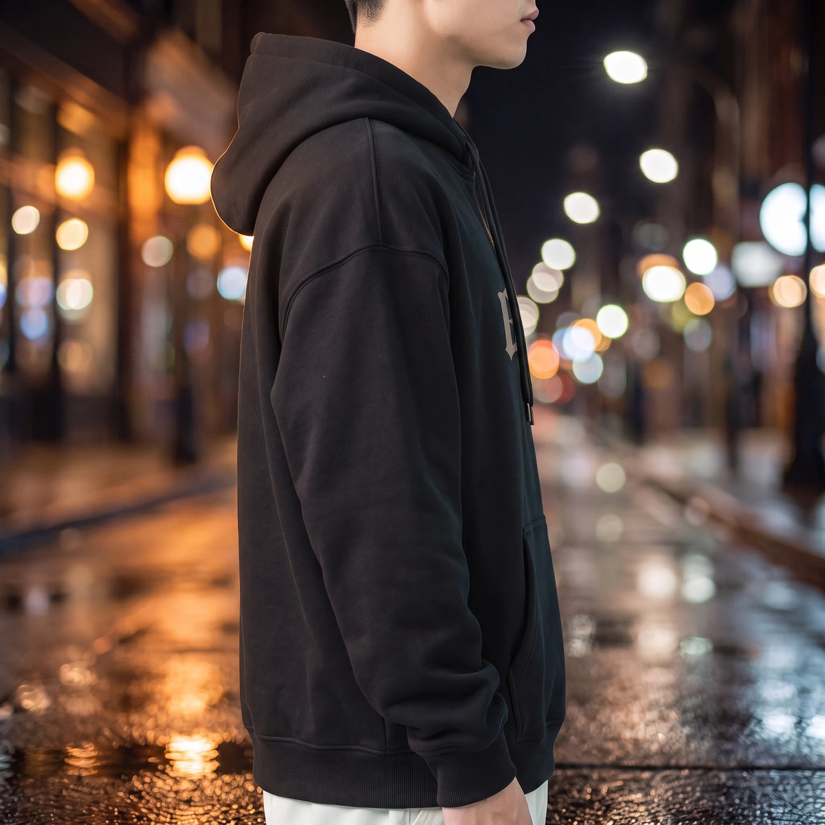 Vallor Gothic Hoodie in black, side profile showing the plain sleeve, hood down and ribbed cuff