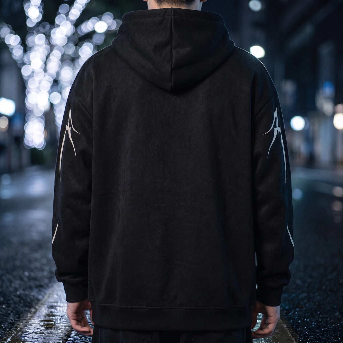 Vaskel Thorn Hoodie in Black, back view showing the plain unprinted back panel, hood down and ribbed hem