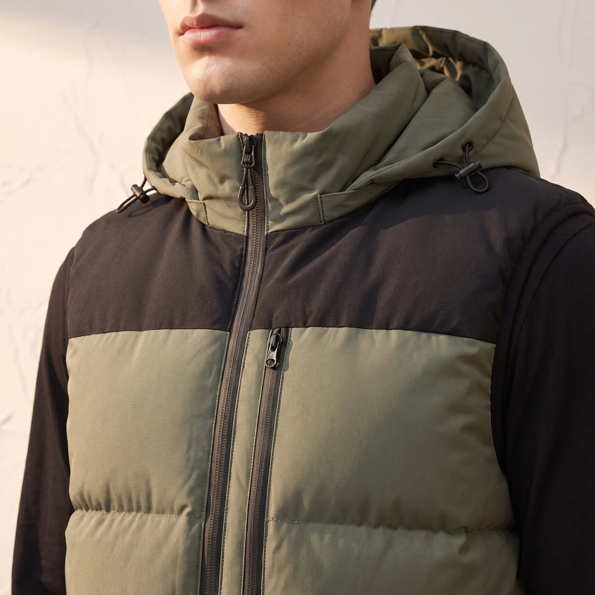 Ashcombe Utility Vest close-up detail - detachable hood attachment zip and vertical chest pocket
