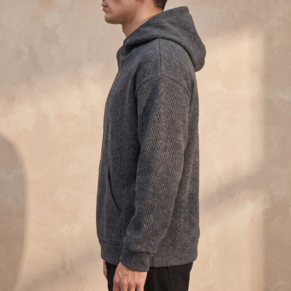 Ostrel Textured Hoodie side view showing the drop-shoulder fit and ribbed cuff