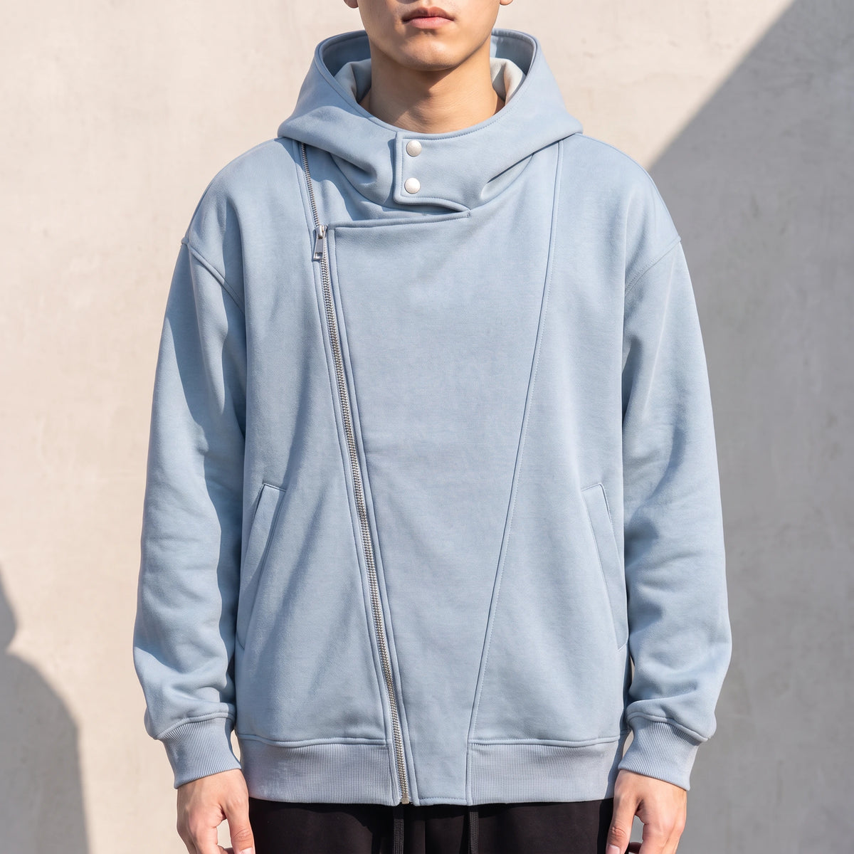 Solteri Collared Hoodie in Blue, oversized bonded fleece hooded jacket with asymmetric diagonal zip and snap storm collar, worn front view