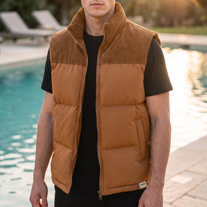 Brancourt Puffer Vest in Tan - quilted sleeveless vest with corduroy stand collar worn by a model poolside