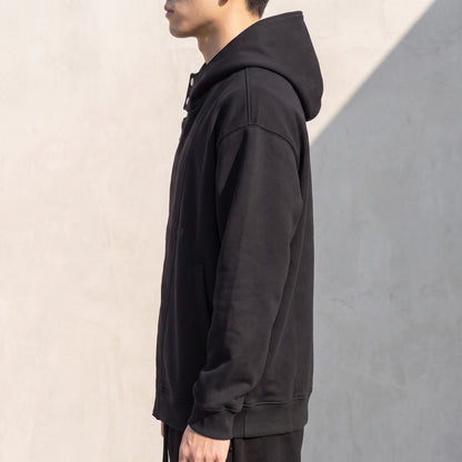 Solteri Collared Hoodie side view showing the oversized drop-shoulder fit and hood resting on the shoulders