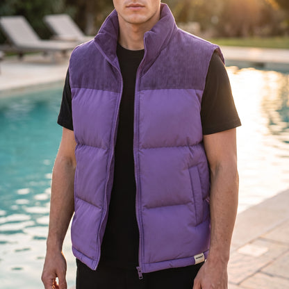 Brancourt Puffer Vest in Purple - quilted sleeveless vest with corduroy stand collar worn by a model poolside